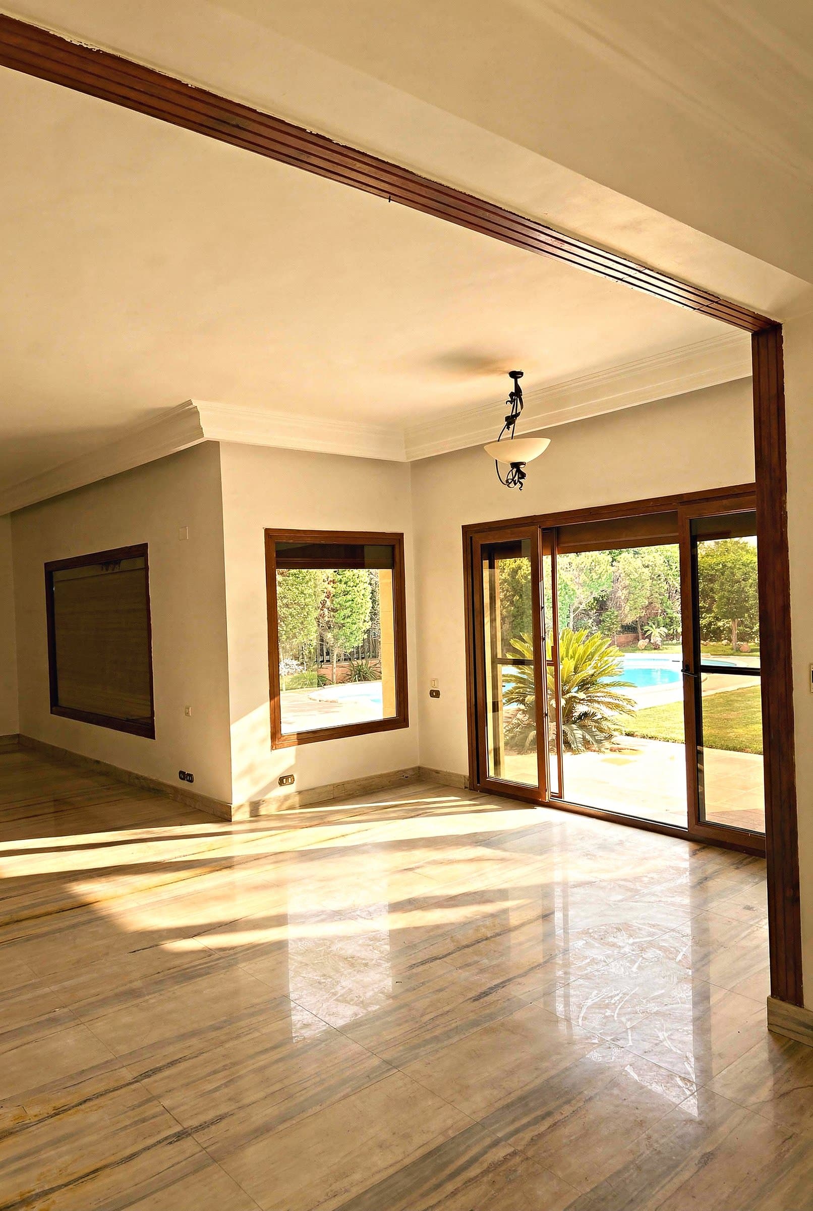 Bright living room opening onto the garden and pool