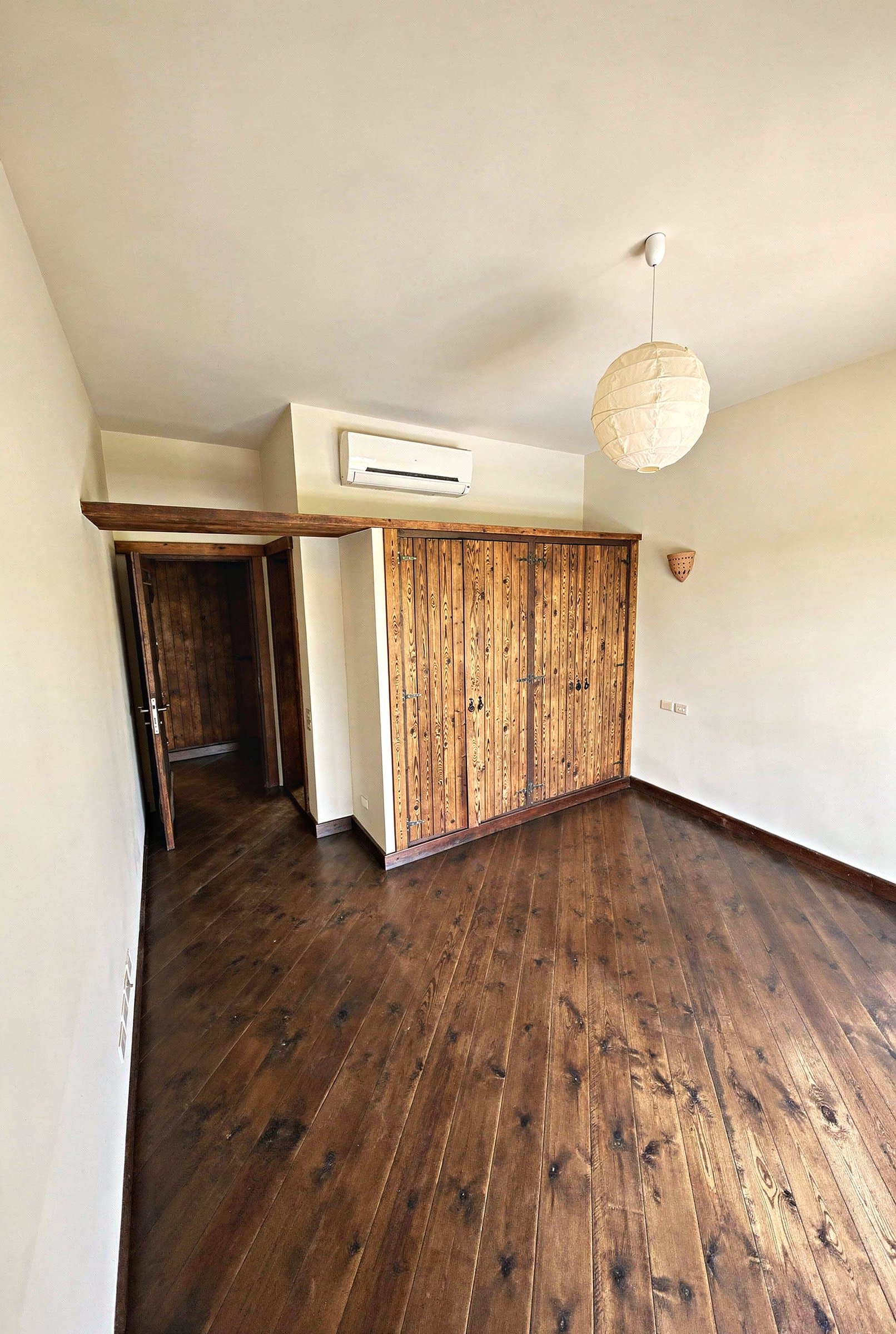 Bedroom with wood furnishings and en-suite dressing area