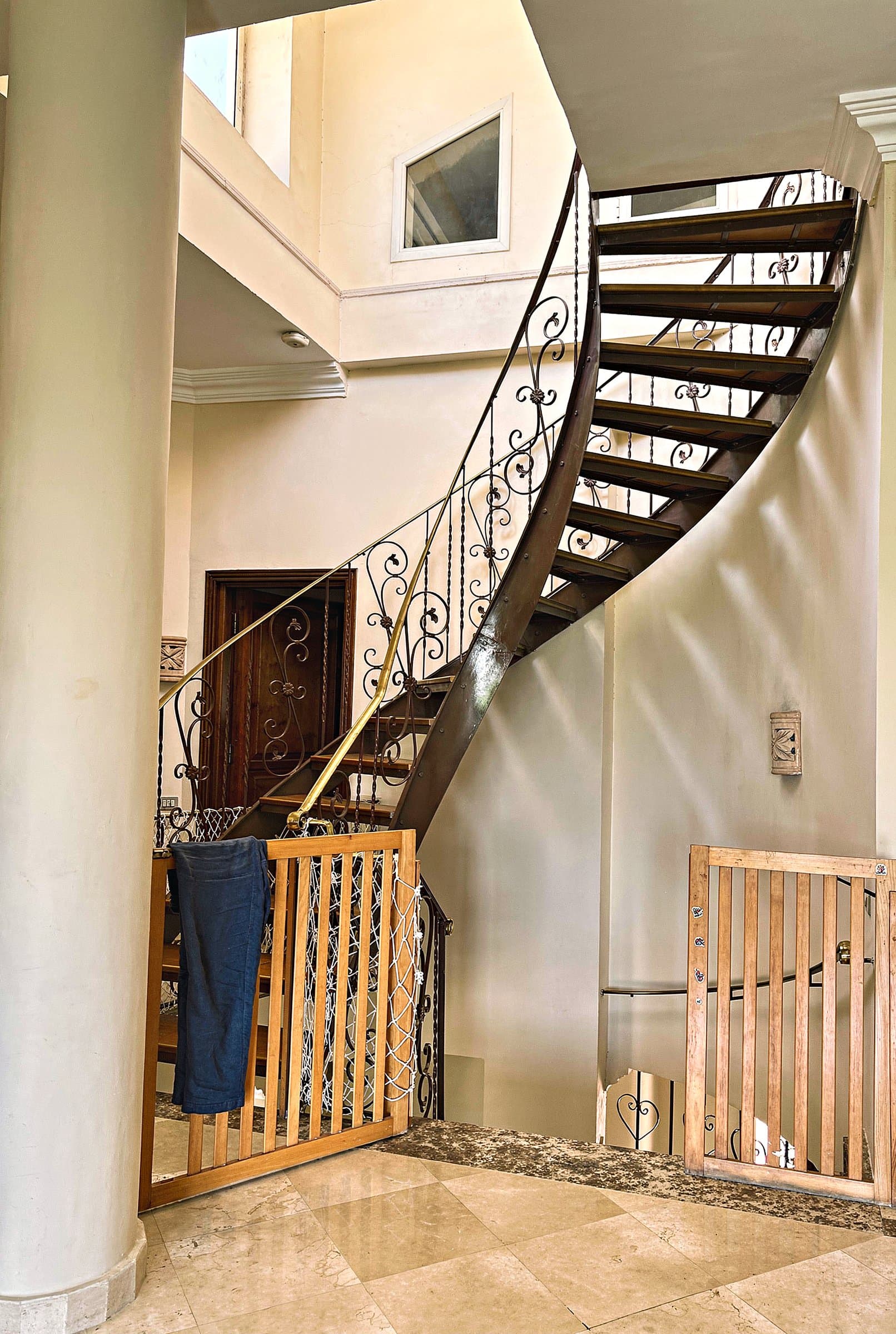 Curved wrought-iron staircase inside the villa