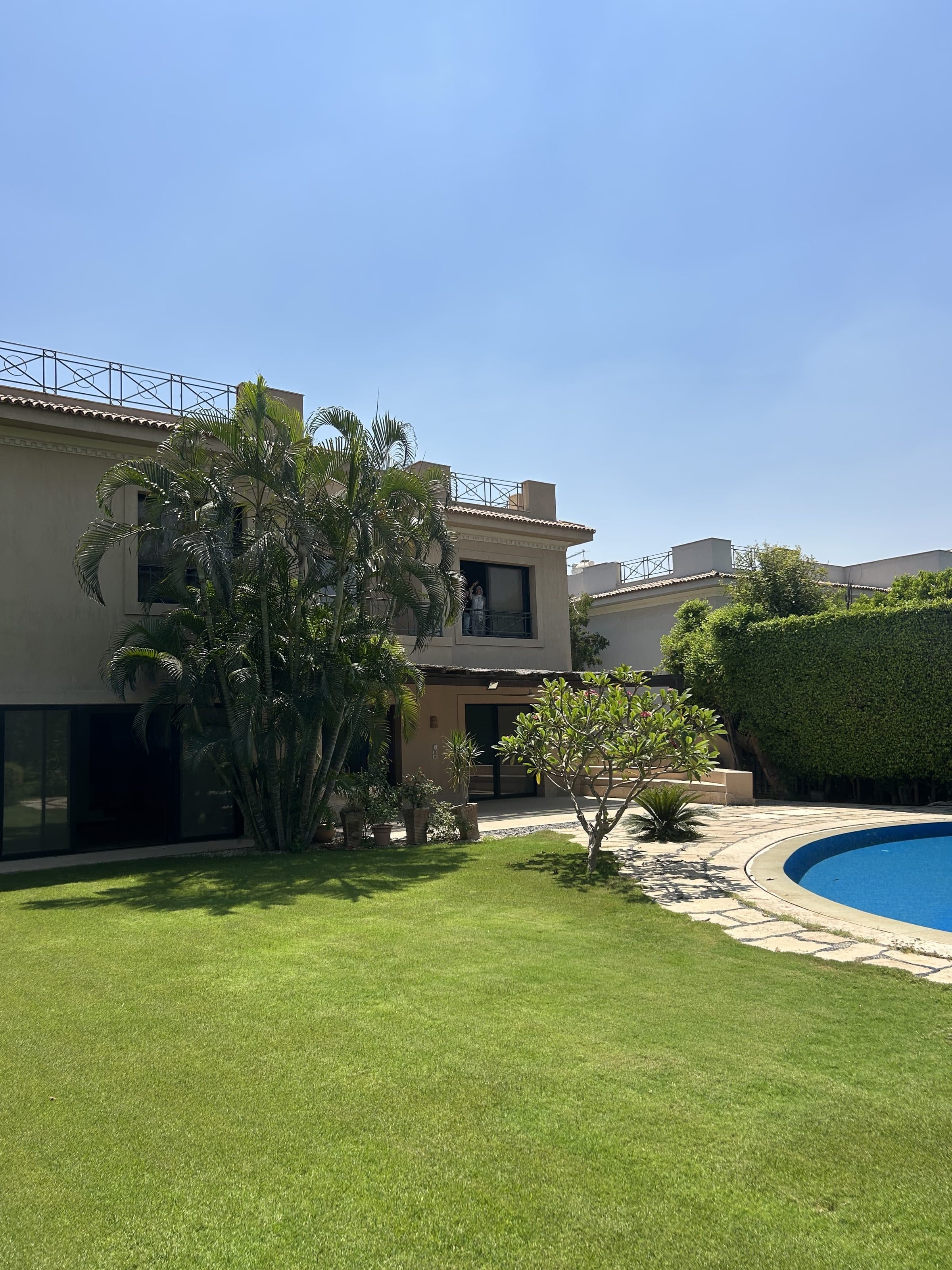 Villa exterior and private pool with lawn in Katameya Heights