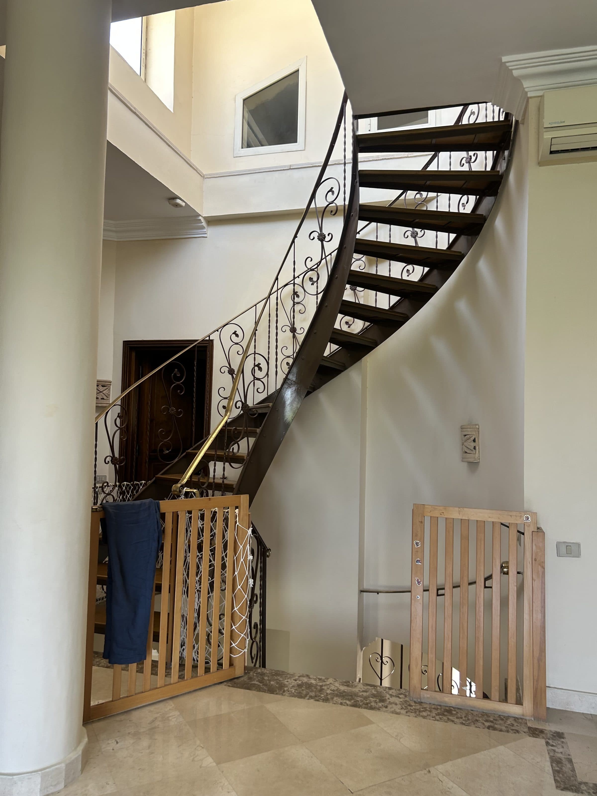 Curved wrought-iron staircase inside the villa
